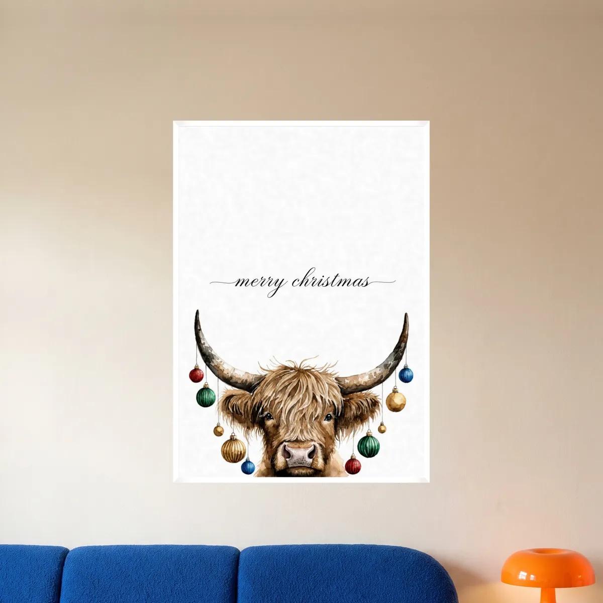 The highland cow Christmas print in a white frame above a blue sofa