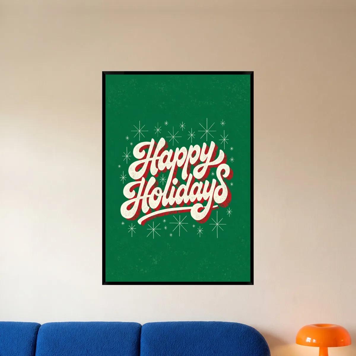 A green retro Happy Holidays lettering print in a black frame above a blue sofa