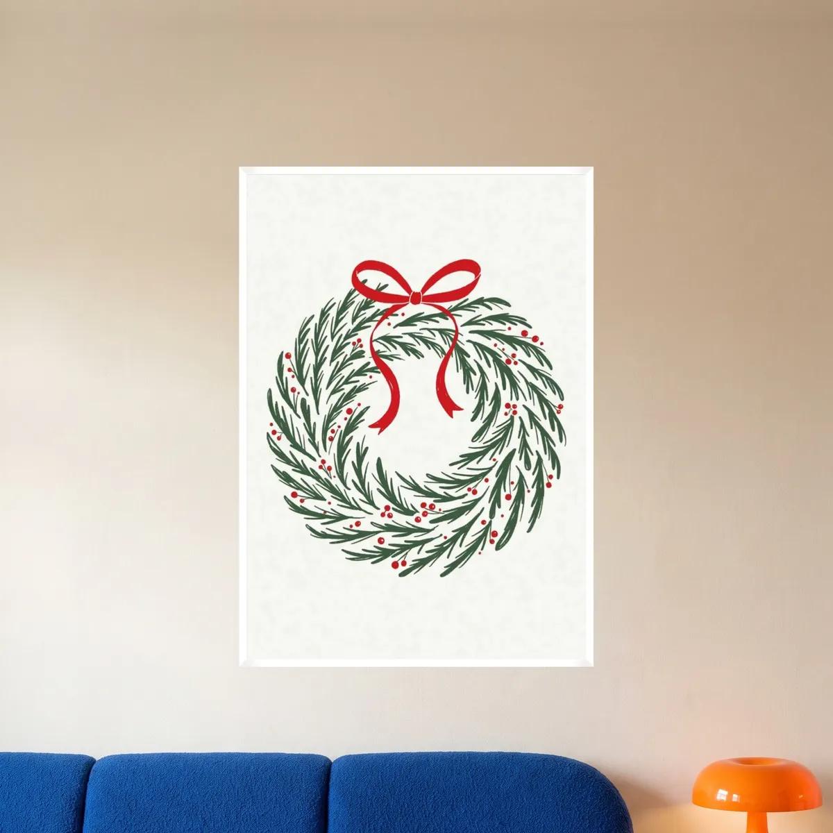 The pine and holly wreath print in a white frame above a blue sofa