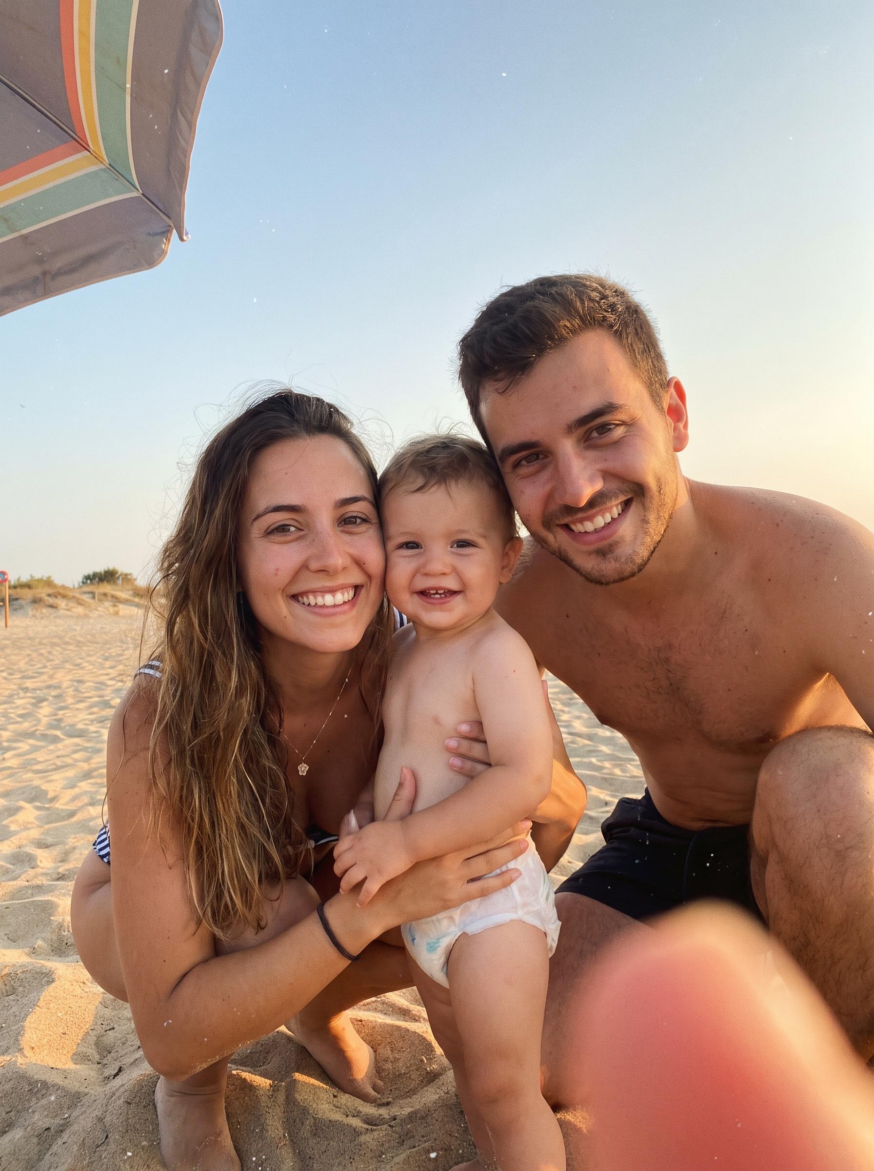 An everyday phone photo of a family on a beach at golden hour